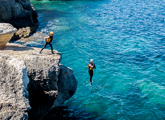 jumping off the cliff into the sea